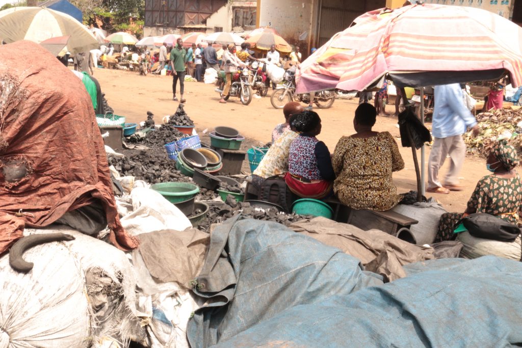 Charcoal traders converse as they wait for clients. By Javier Silas Omagor